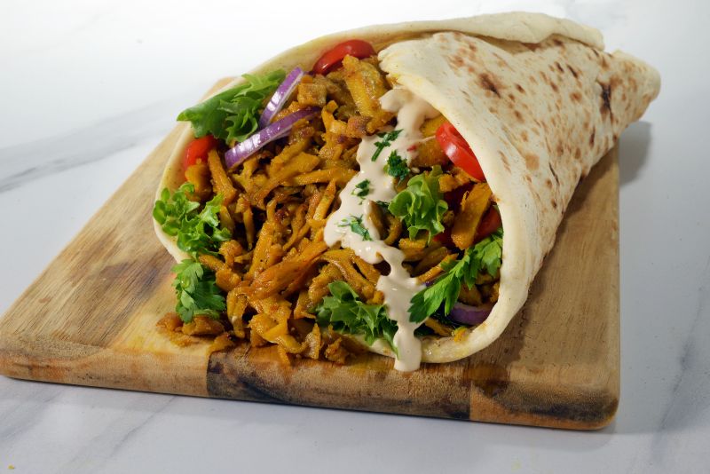 Laffa wrap filled with Provero strips, salad and tahini