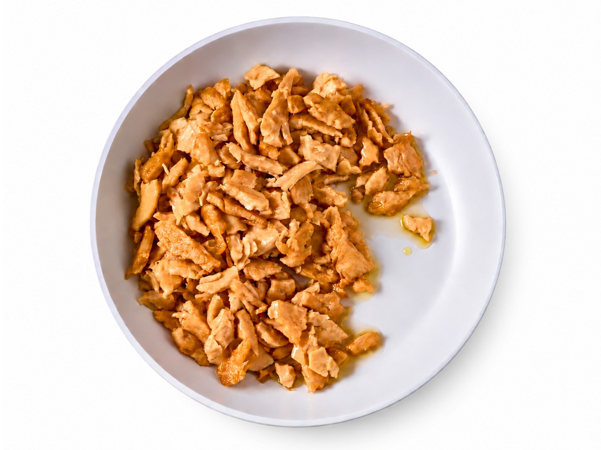 Unseasoned plant-based protein chunks in a white bowl
